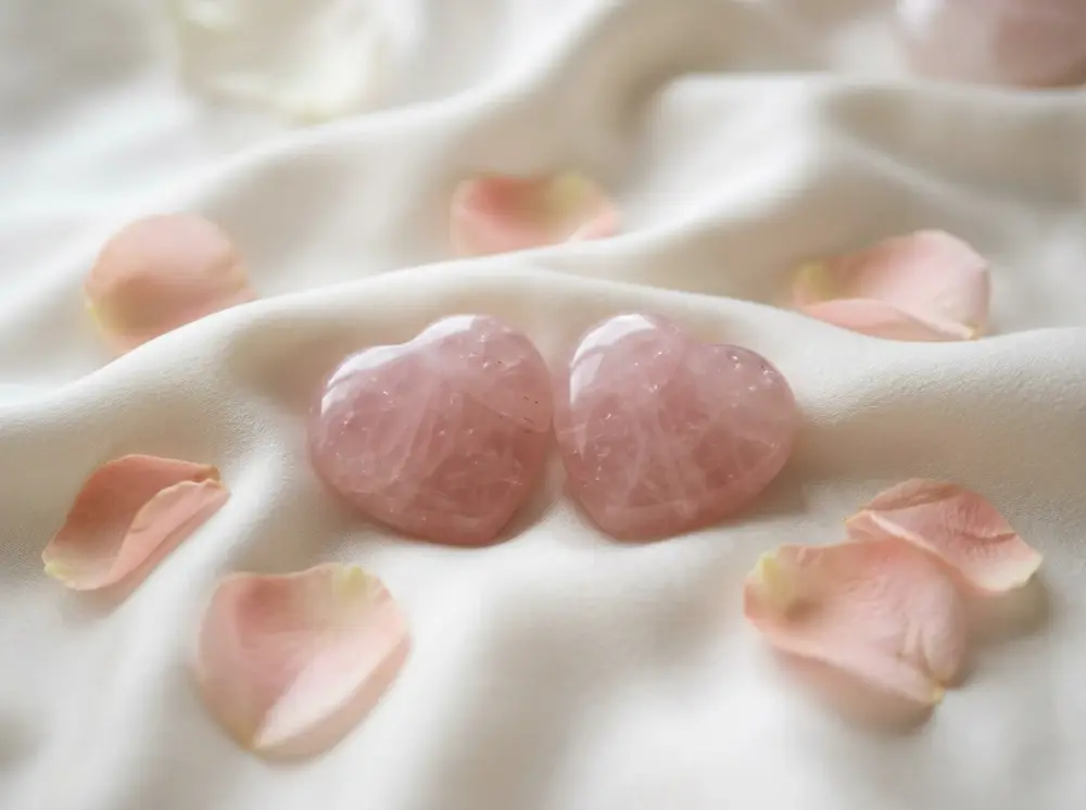 Two rose-quartz heart stones on ivory silk for love readings in Woodland Hills